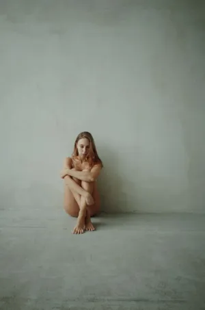 Nude Woman Sitting On Floor