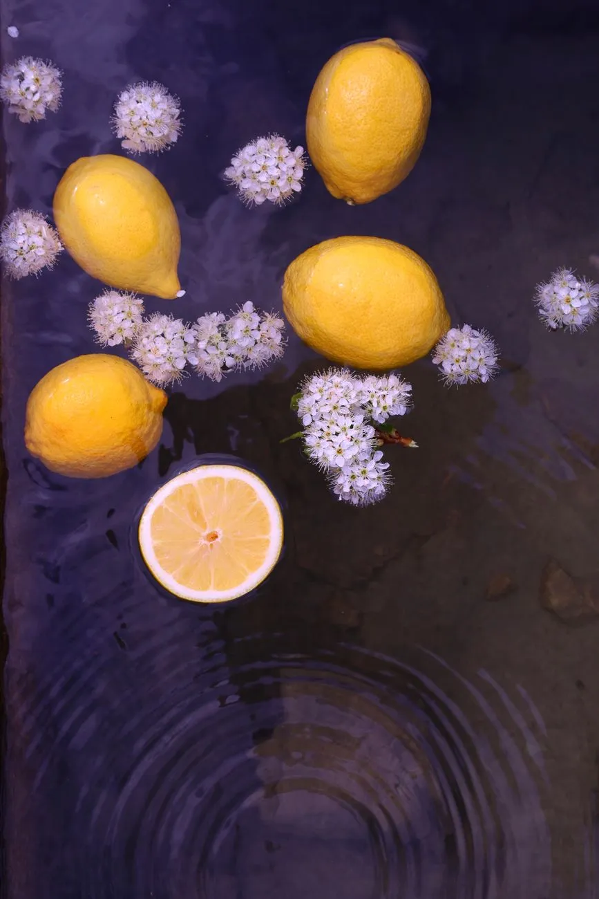 Lemon And Flowers In Water