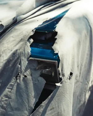 Torn Tarp Covering Car