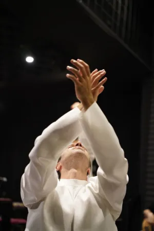 Man In White Shirt With Hands Raised