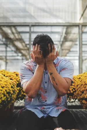 Man With Hands Covering Face