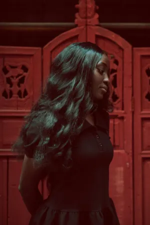 Black Woman In Front Of Red Door