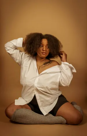 Sitting Pose With White Shirt And Black Shorts