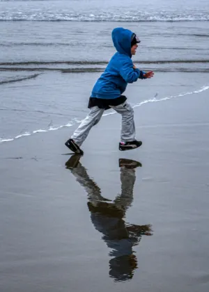 Child Running On Beach