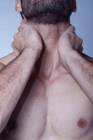 Man With Hands On Neck