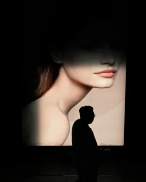 Silhouette Of A Person Against A Woman'S Face