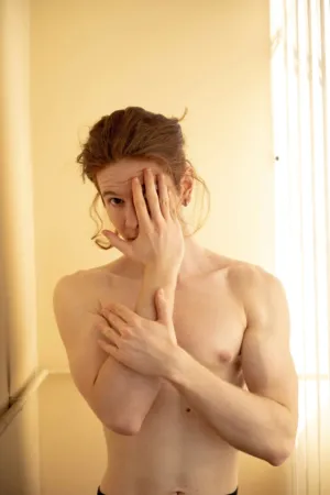 Shirtless Man With Hand Covering Face