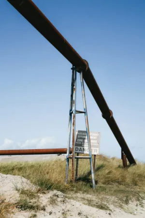 Rusty Pipeline And Warning Sign