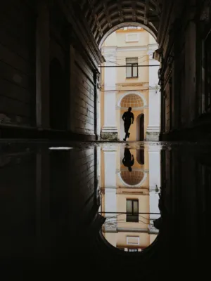 Silhouette Of A Person Running Through An Archway