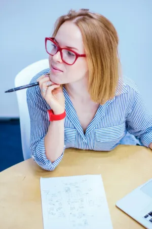 Pensive Woman With Red Glasses