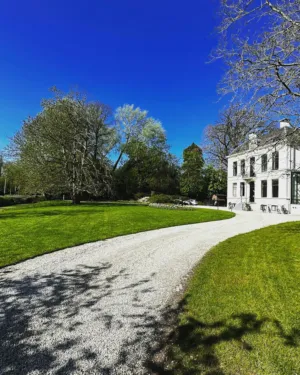 Grass Path Leading To A Mansion