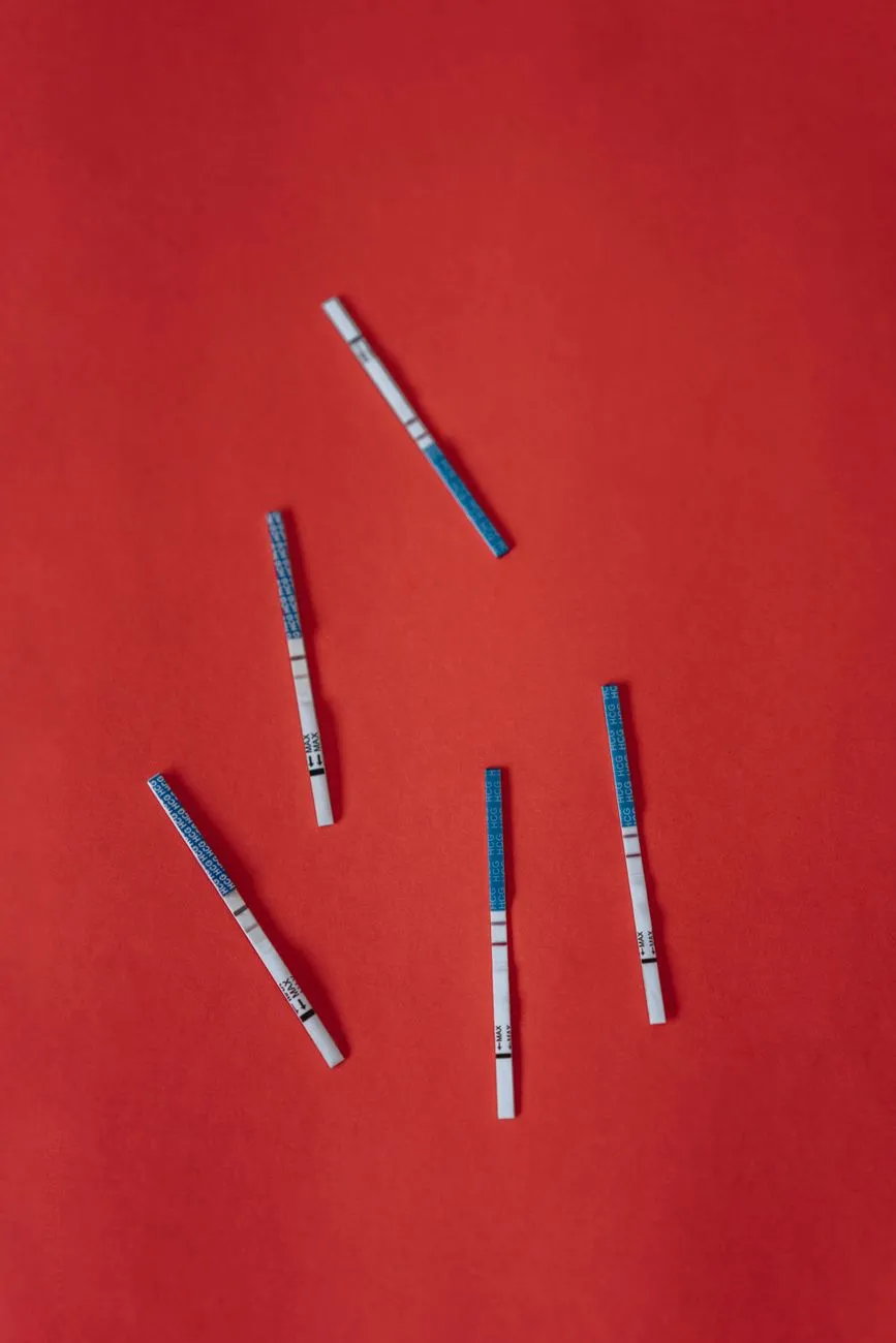Five Pregnancy Tests On Red Background