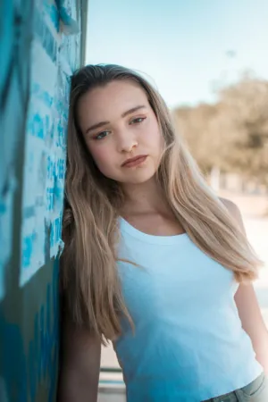 Teenage Girl Leaning On Wall