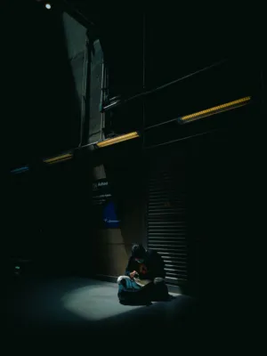 Lonely Figure In Dark Urban Setting