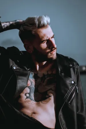 Tattooed Man In Leather Jacket