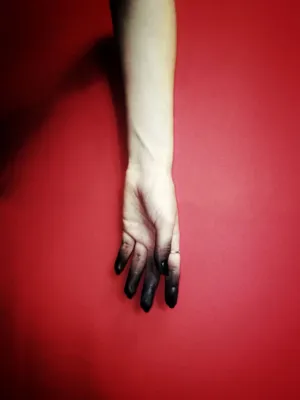Black Hand On Red Background