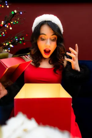 Excited Woman Opening Christmas Gift