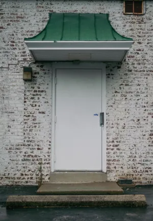 White Door With Green Awning