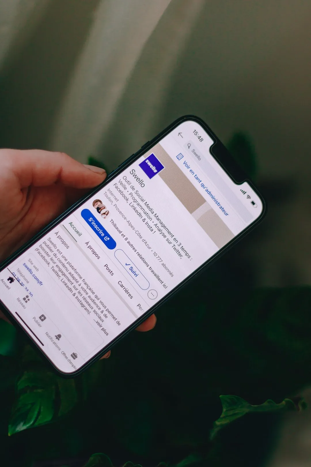 Hand Holding Smartphone With Social Media Page