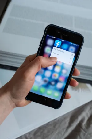 Hand Holding Iphone With Facebook App