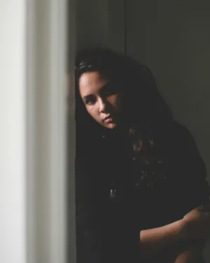 Pensive Woman In Dark Room