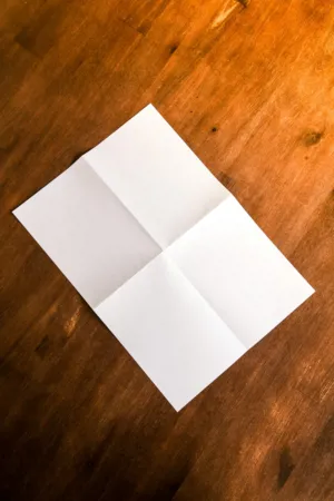 Folded Paper On Wooden Surface