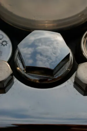 Reflection Of Clouds On A Car Wheel Nut