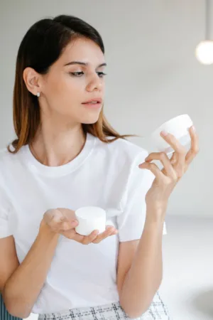 Woman Holding Cream Containers