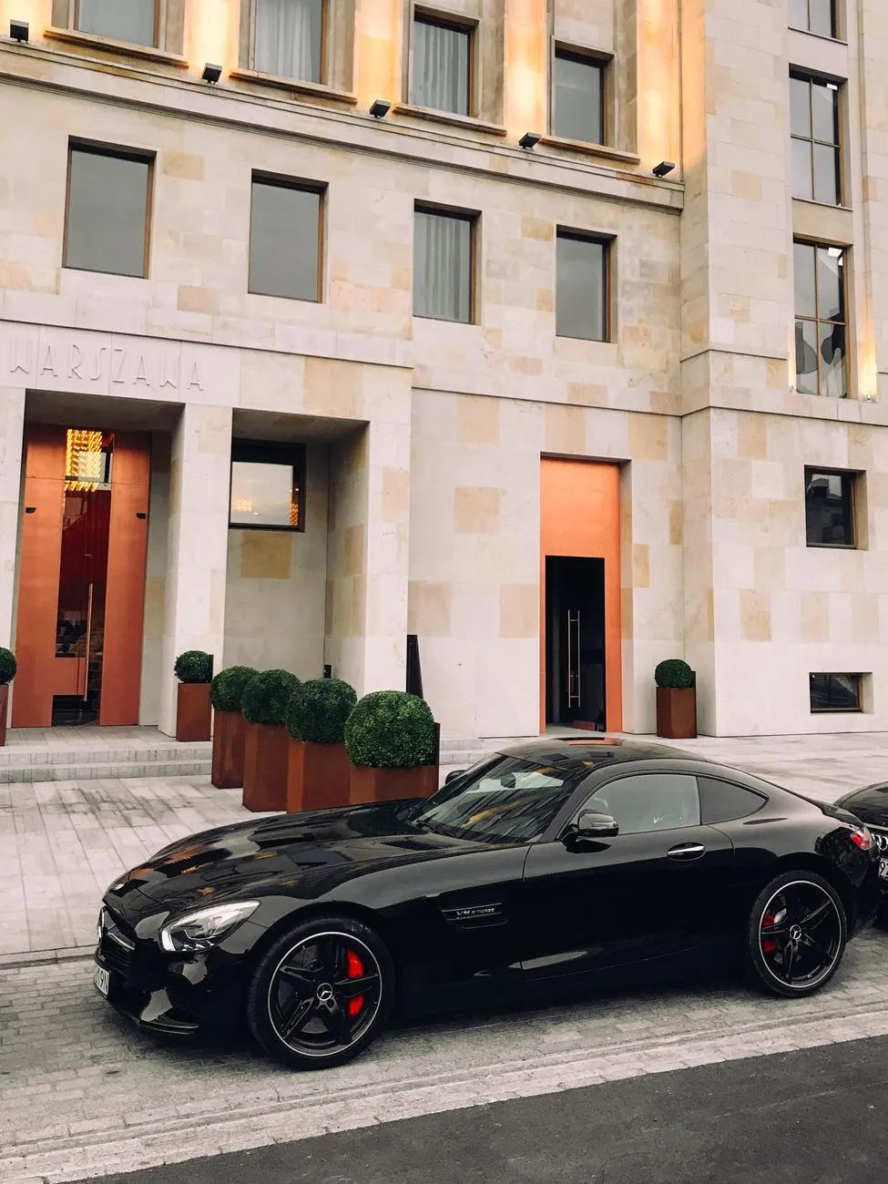 Black Luxury Car In Front Of Building