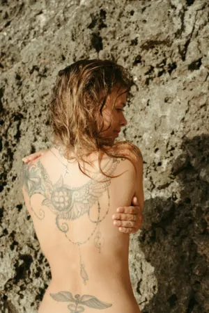 Tattooed Woman By Rock