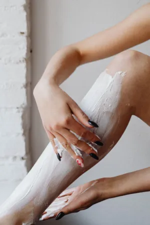 Applying Cream On Legs