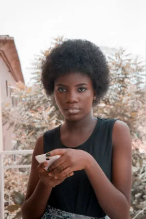 Young Woman With Afro Holding Phone