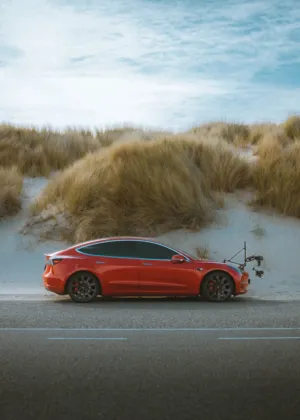 Red Tesla Model 3 On Beach