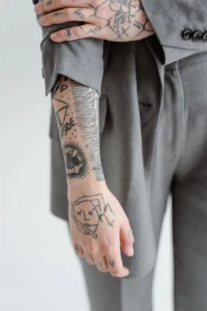 Tattooed Arm In Gray Suit