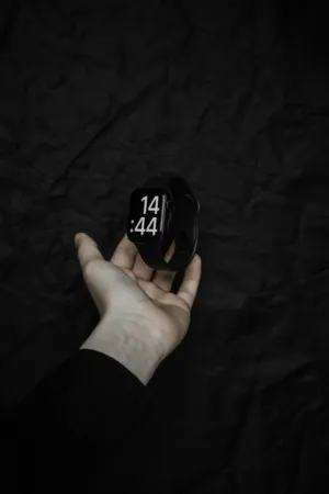 Hand Holding A Black Smartwatch