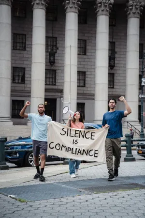 Protestors With 'Silence Is Compliance' Banner