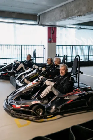 Elderly Friends Enjoying A Go-Kart Ride