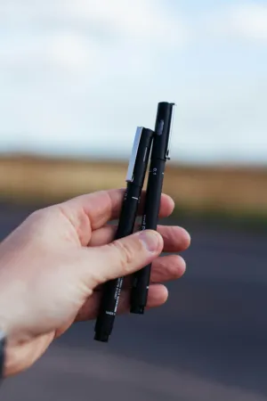 Hand Holding Pens