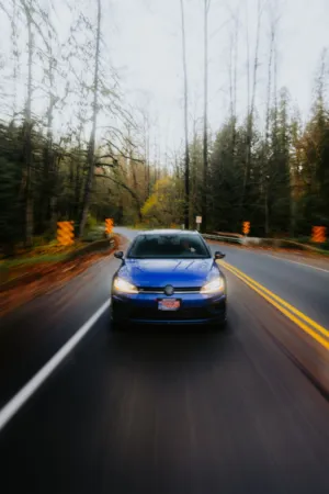 Blue Car On Forest Road