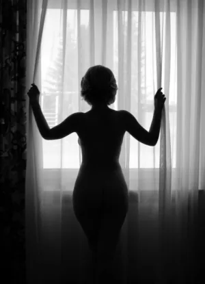 Silhouette Of A Nude Woman At A Window
