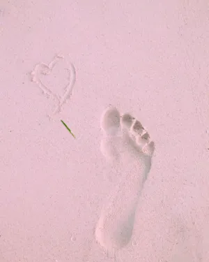 Footprint And Heart In The Sand