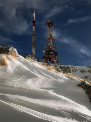 Snowy Mountain With Communication Towers