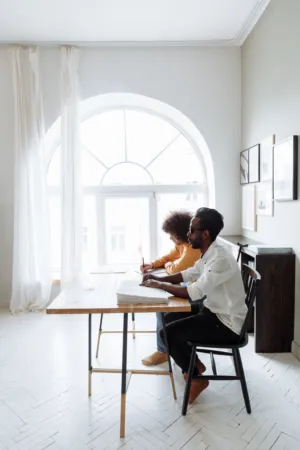 Two People Studying At A Desk