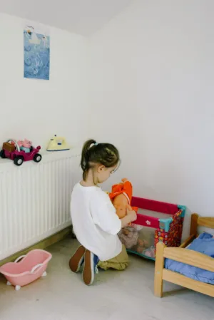 Child Playing With Dolls