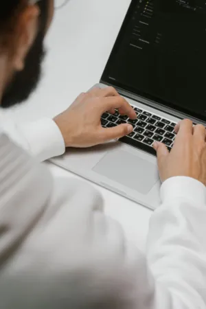 Man Typing On Laptop