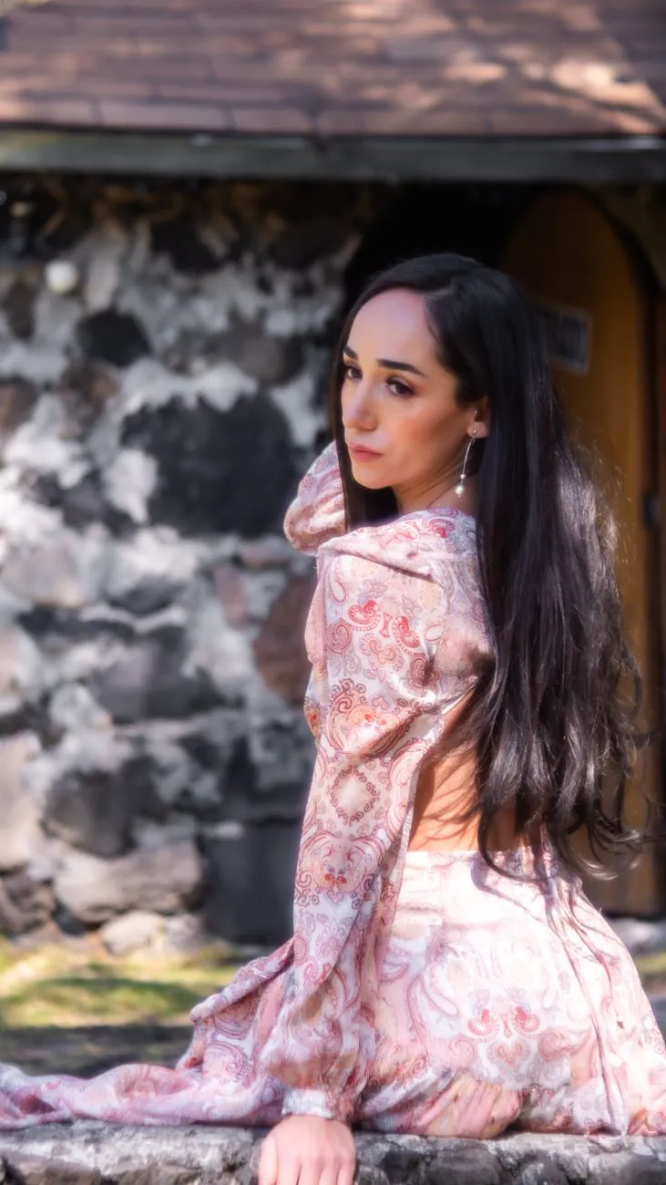 Elegant Woman In Front Of Stone Wall