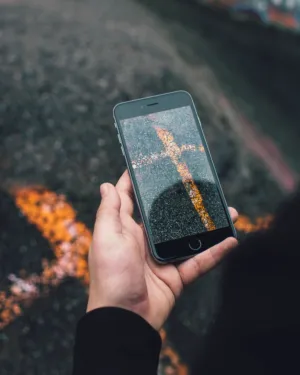 Hand Holding Smartphone With Reflective Screen