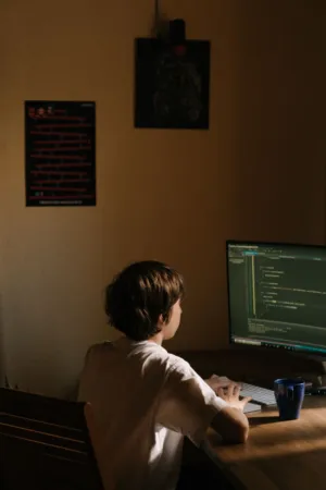 Teenager Coding At Desk