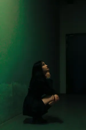 Crouching Figure In Dark Room