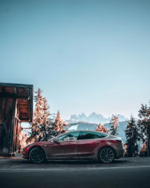 Red Tesla Model 3 In The Mountains
